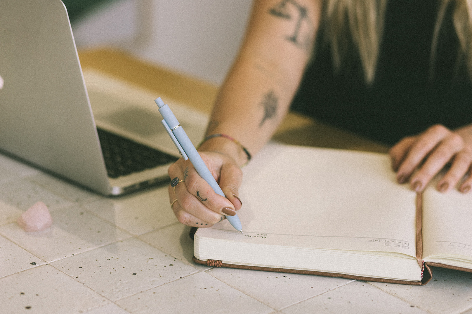 A notebook and laptop on a table